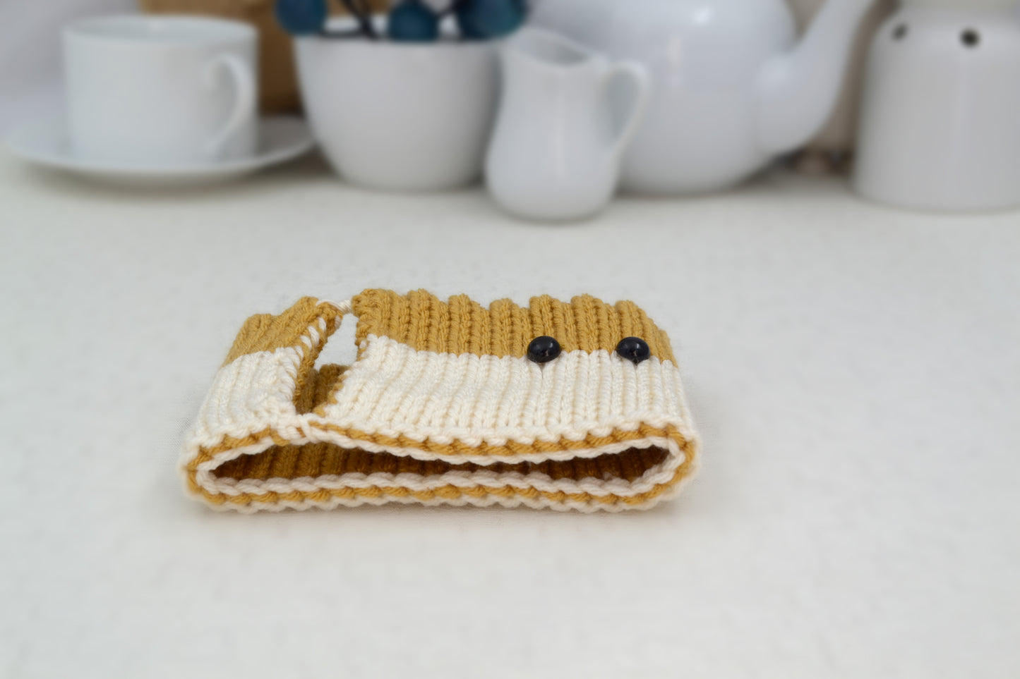 Knitted Mug Cozy with black eyes