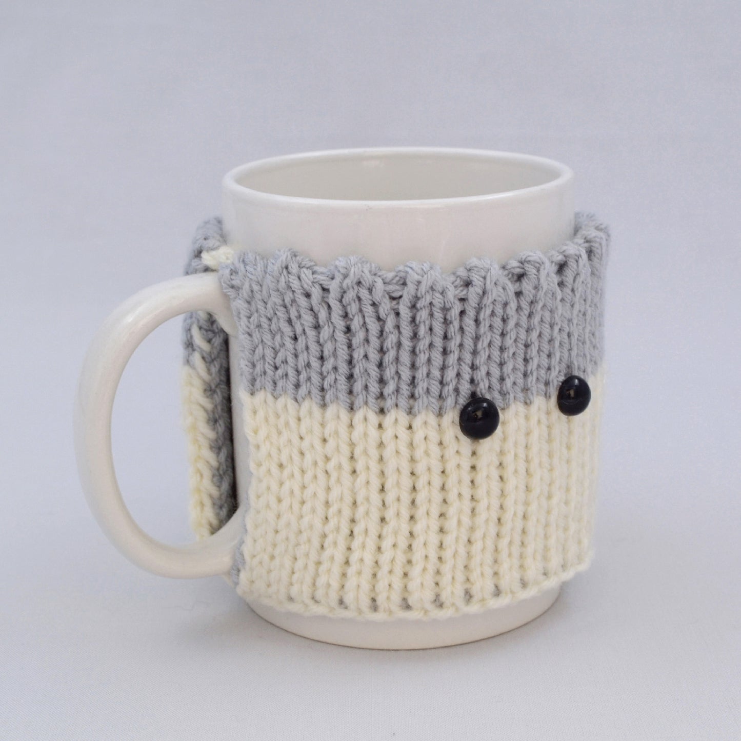 Knitted Mug Cozy with black eyes