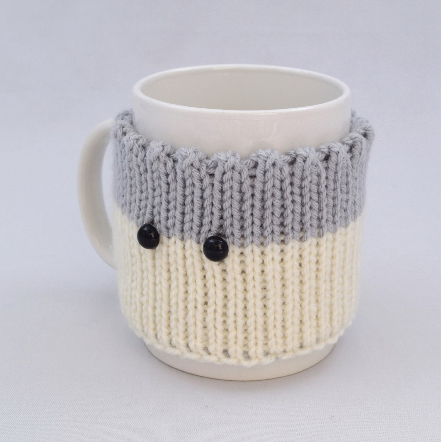 Knitted Mug Cozy with black eyes