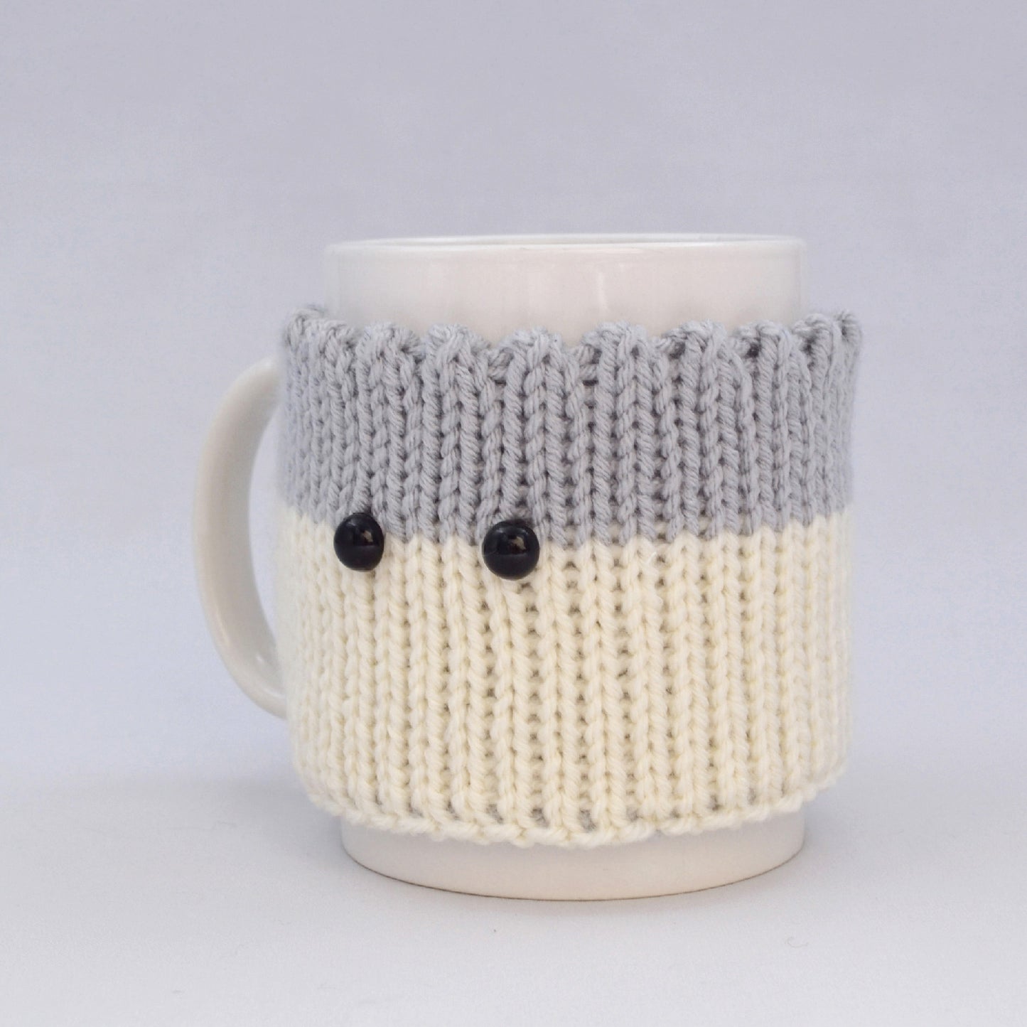 Knitted Mug Cozy with black eyes