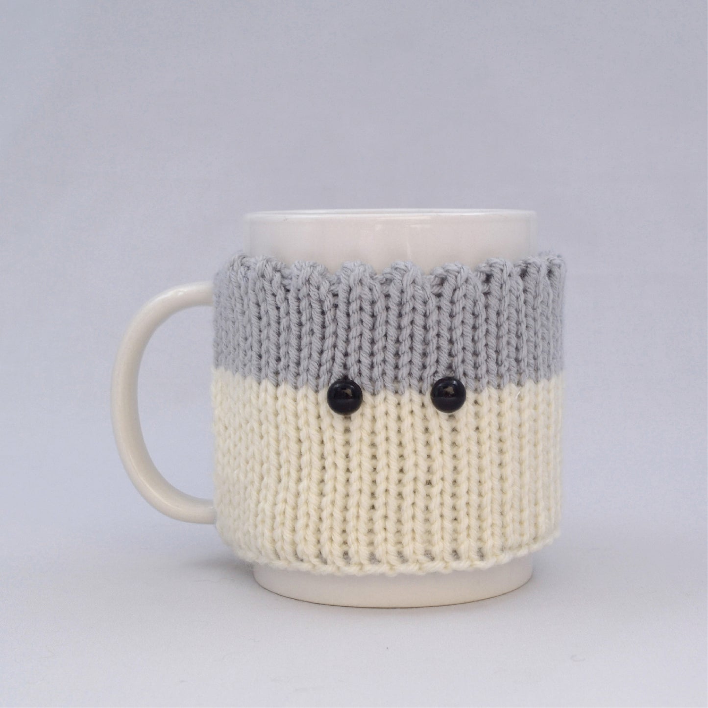 Knitted Mug Cozy with black eyes