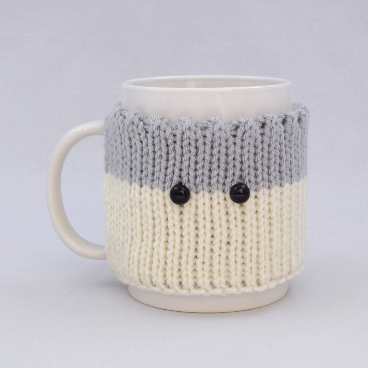 Knitted Mug Cozy with black eyes