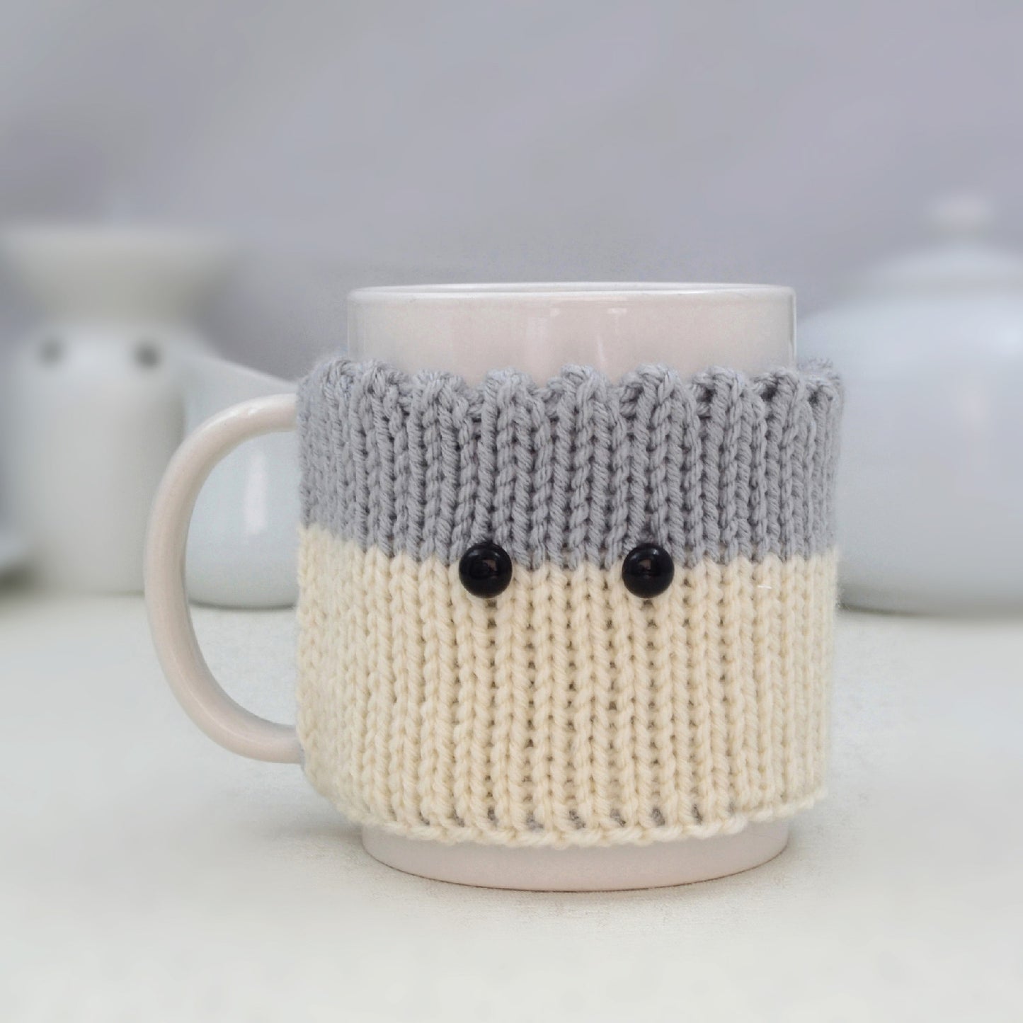 Knitted Mug Cozy with black eyes