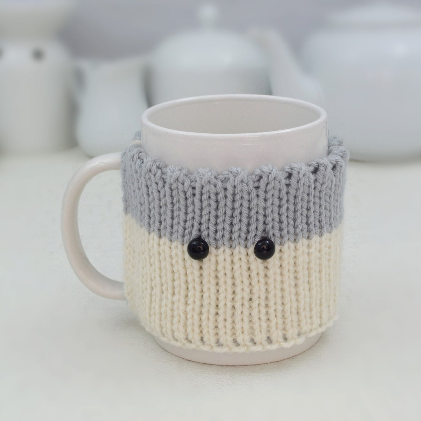 Knitted Mug Cozy with black eyes