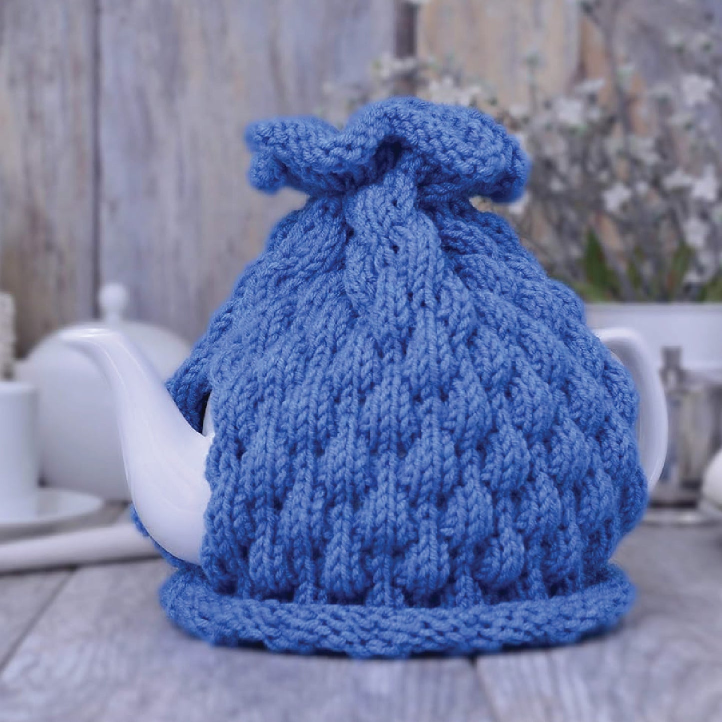 Blue knitted teapot cozy