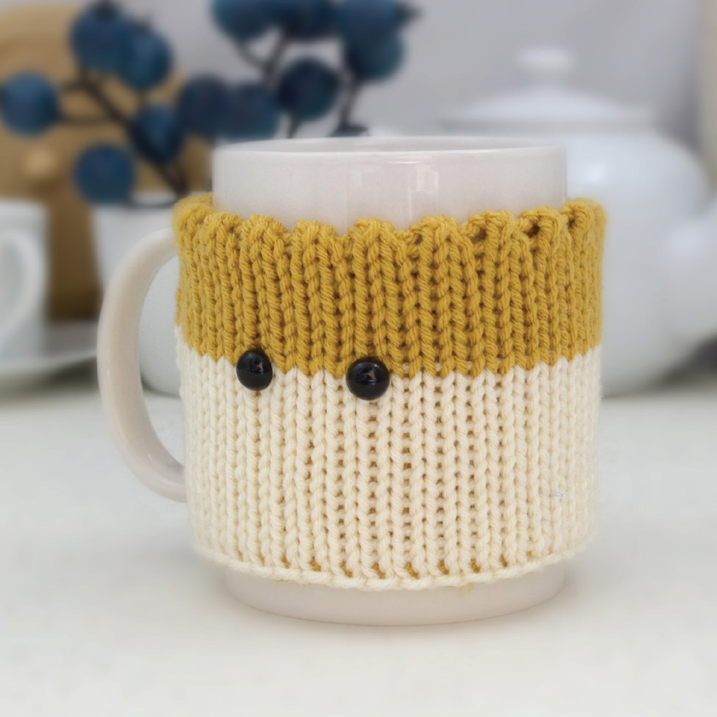 Knitted Mug Cozy with black eyes