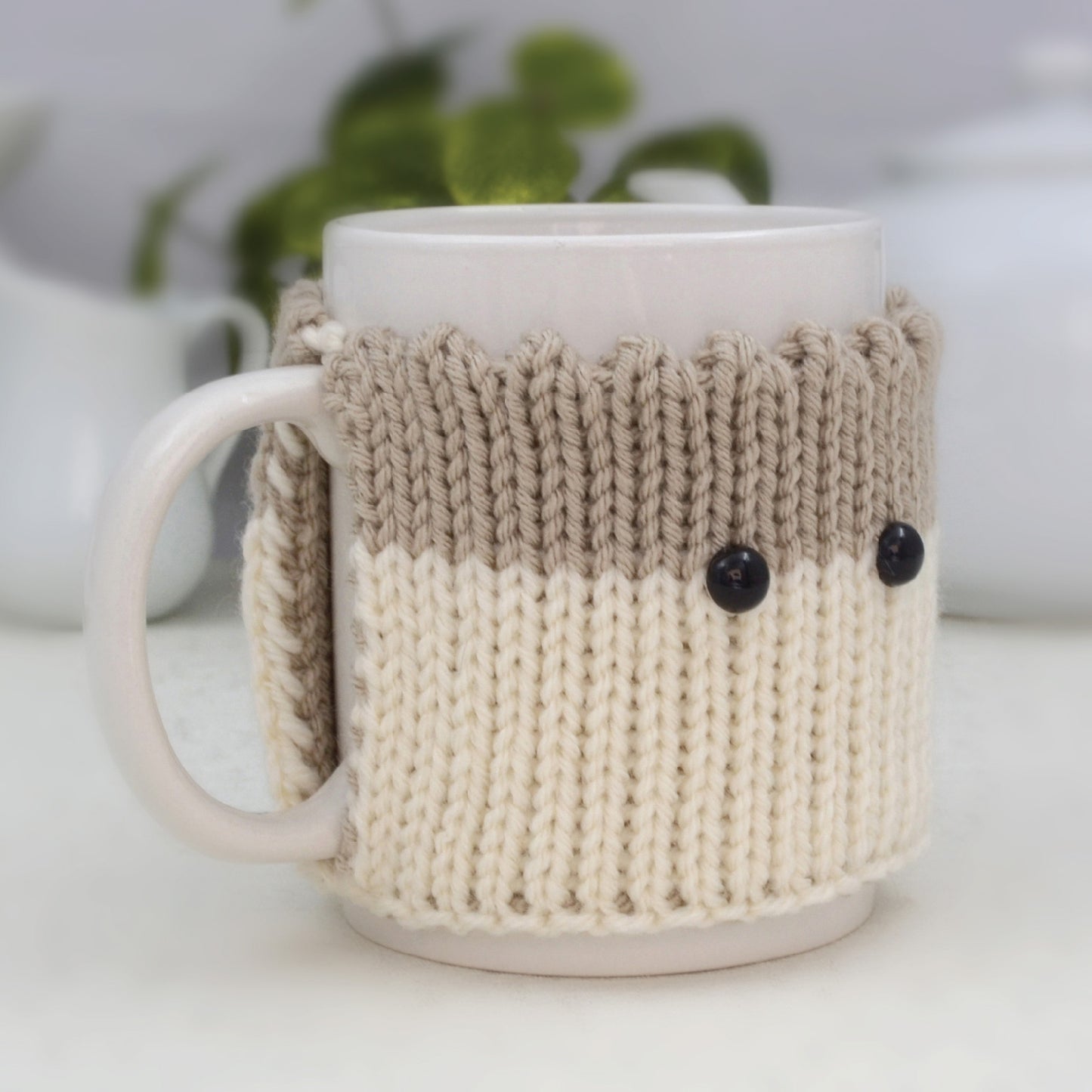 Knitted Mug Cozy with black eyes