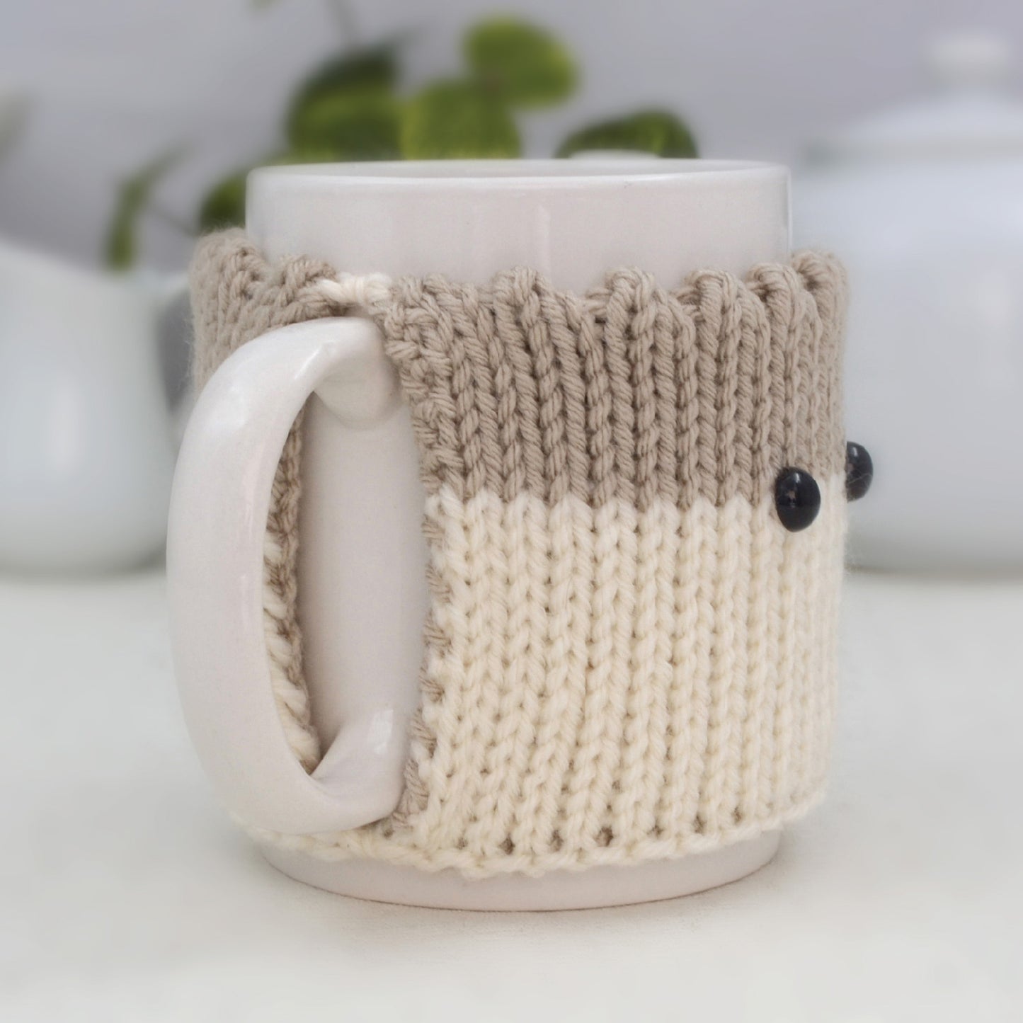 Knitted Mug Cozy with black eyes