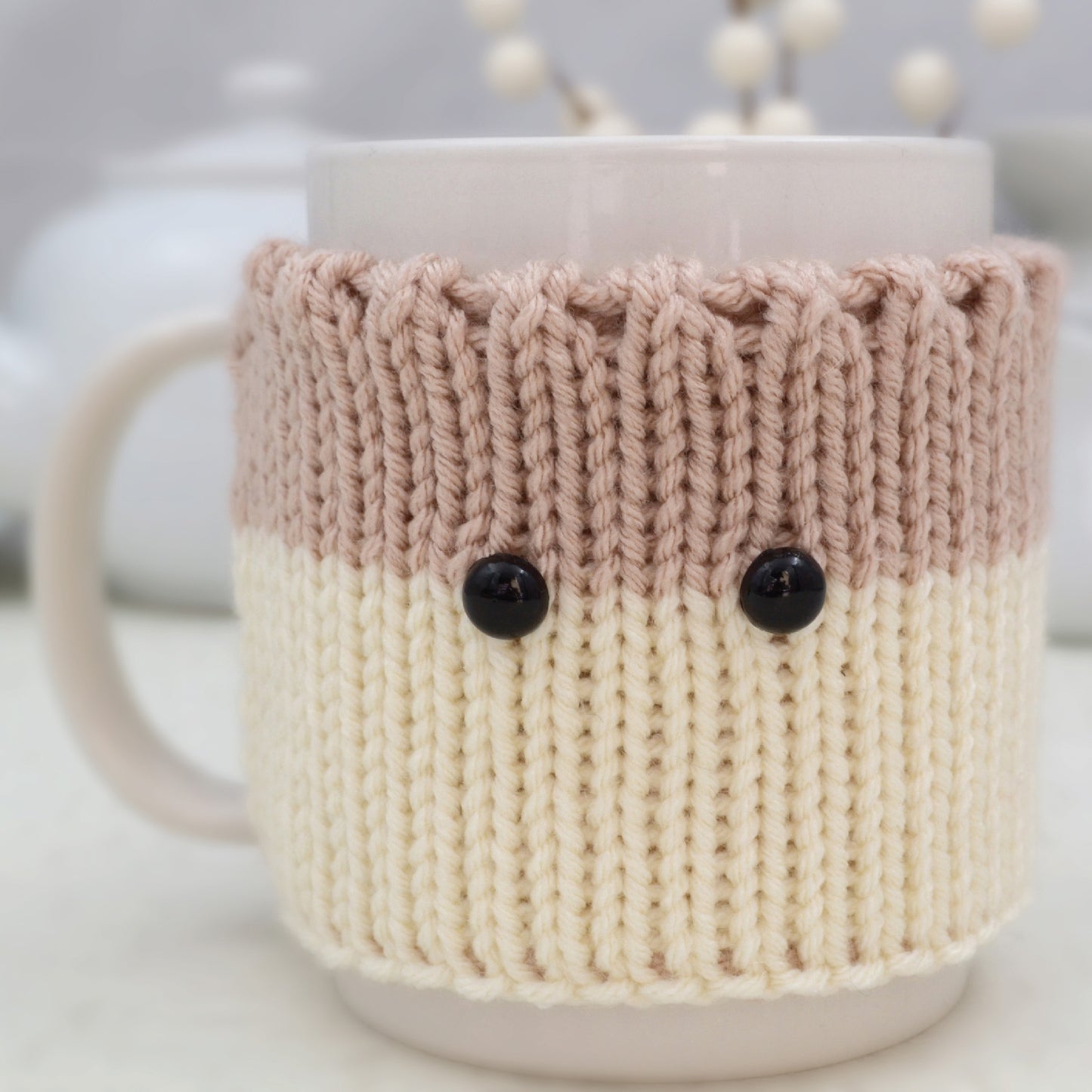 Knitted Mug Cozy with black eyes