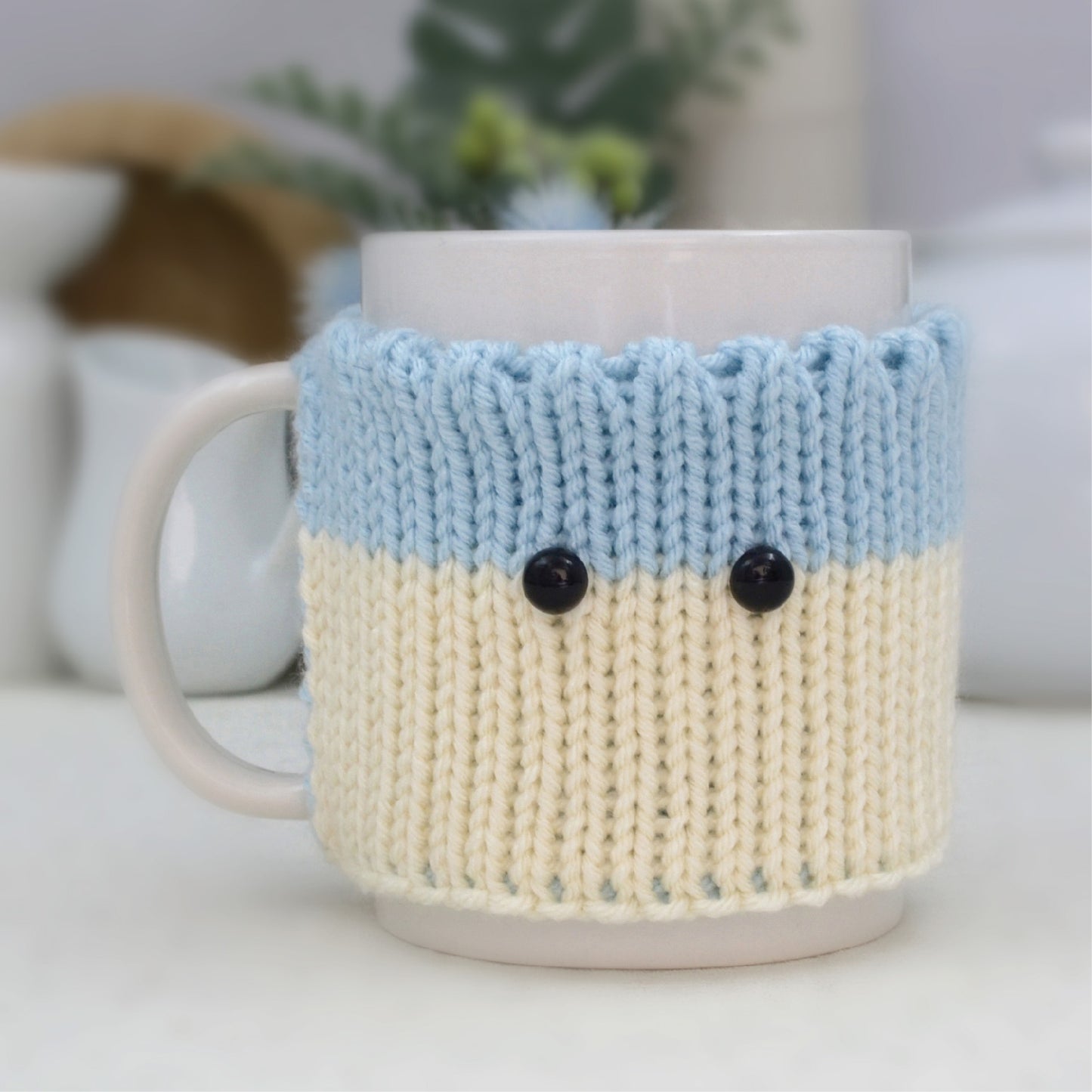 Knitted Mug Cozy with black eyes