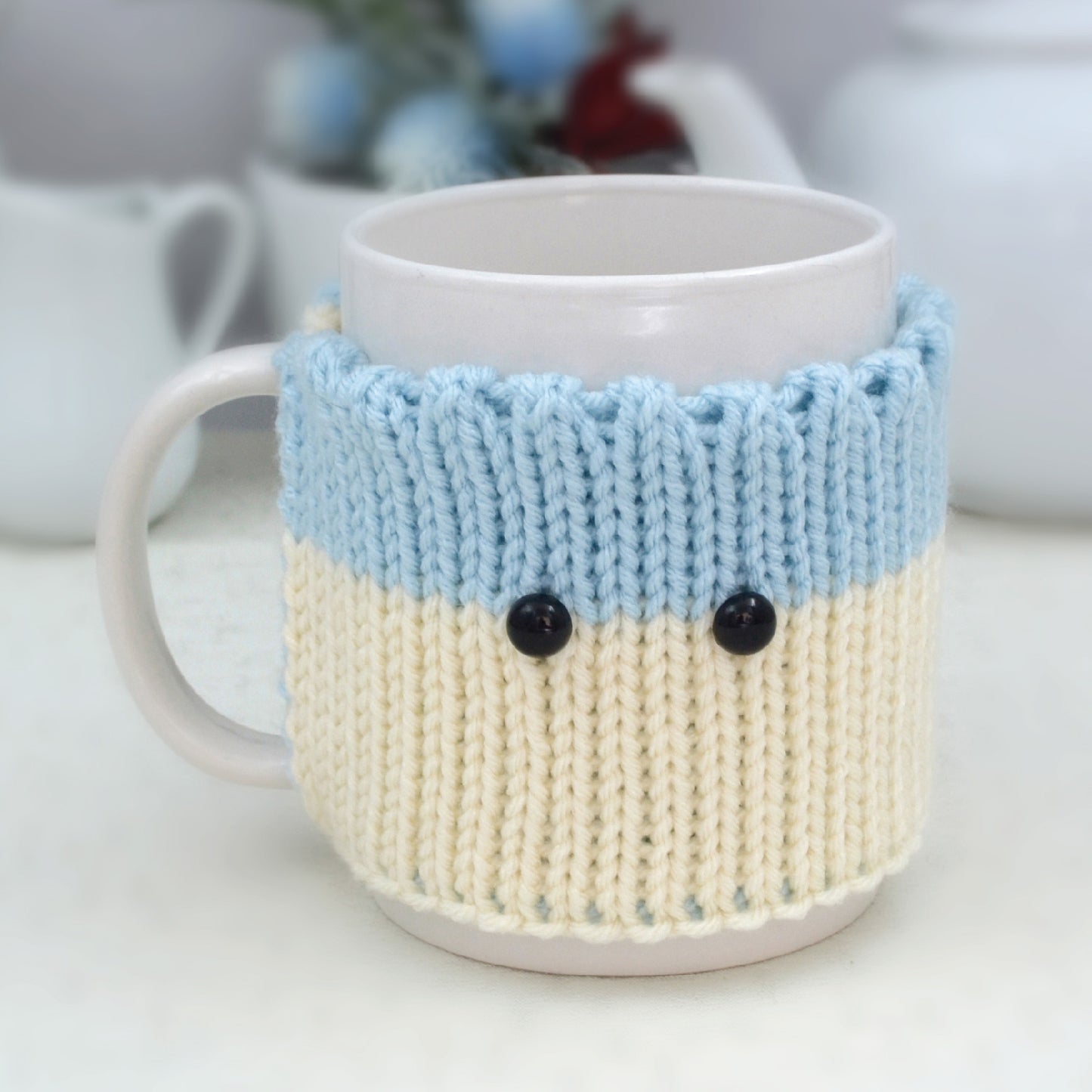 Knitted Mug Cozy with black eyes