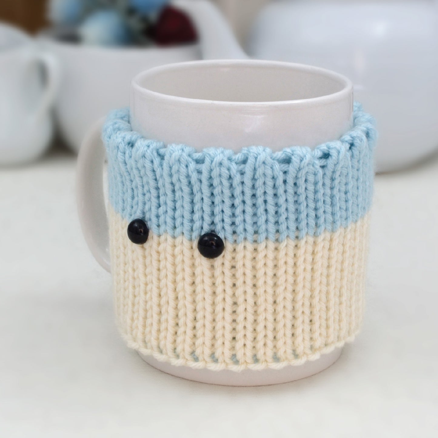 Knitted Mug Cozy with black eyes