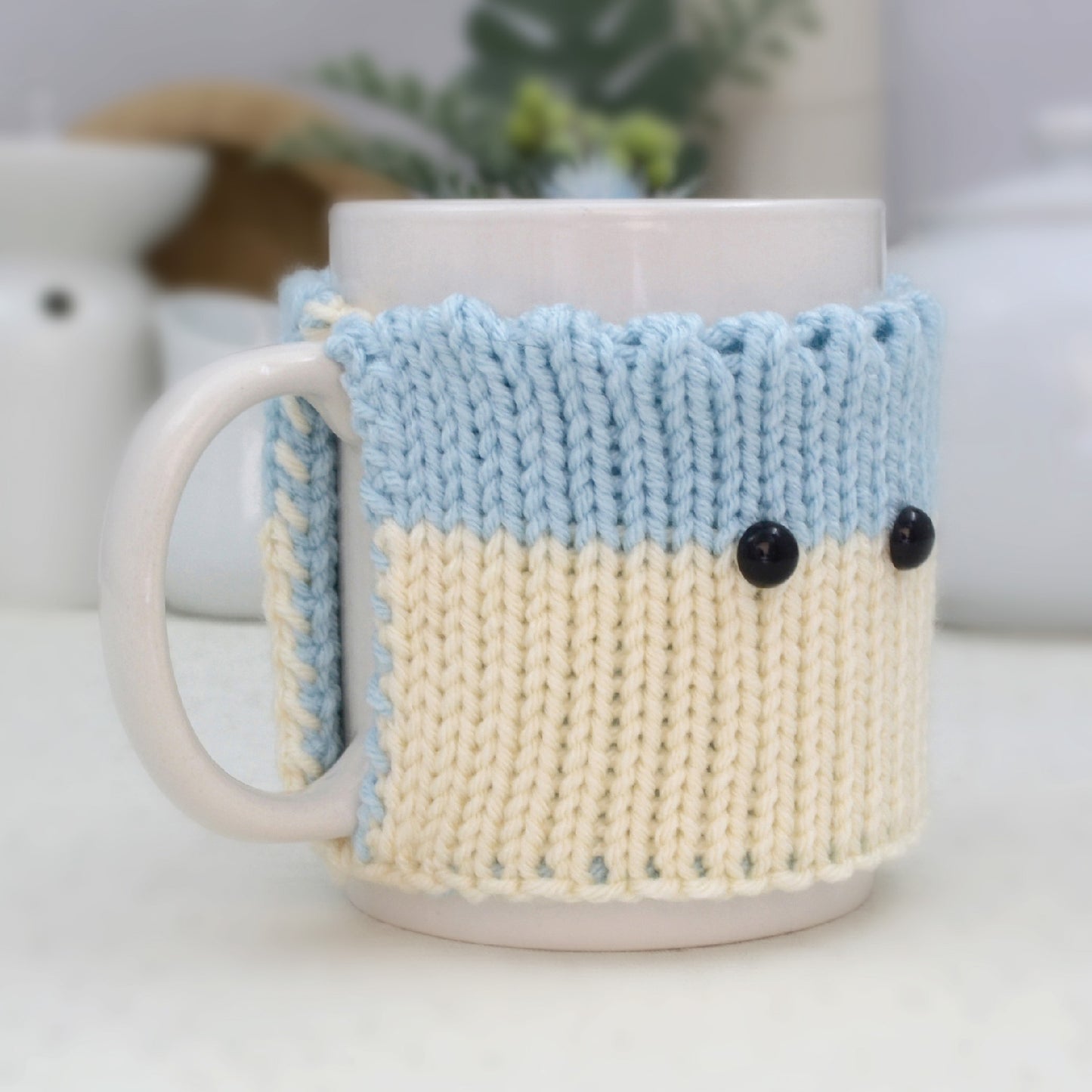 Knitted Mug Cozy with black eyes