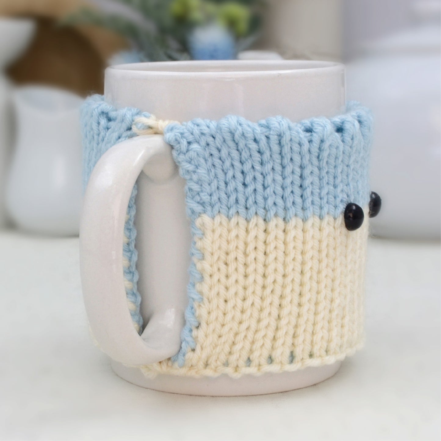 Knitted Mug Cozy with black eyes