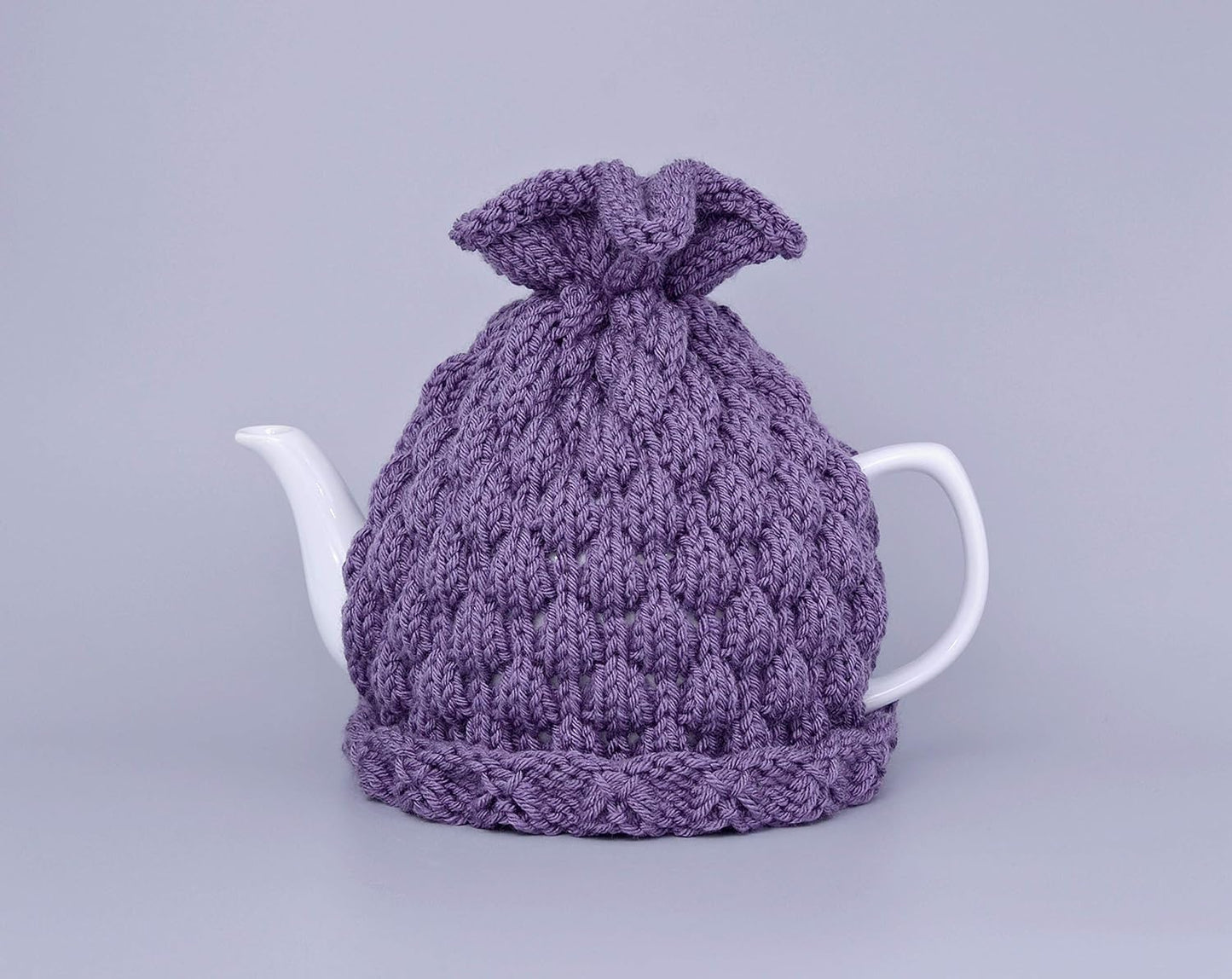 Purple knitted teapot cozy