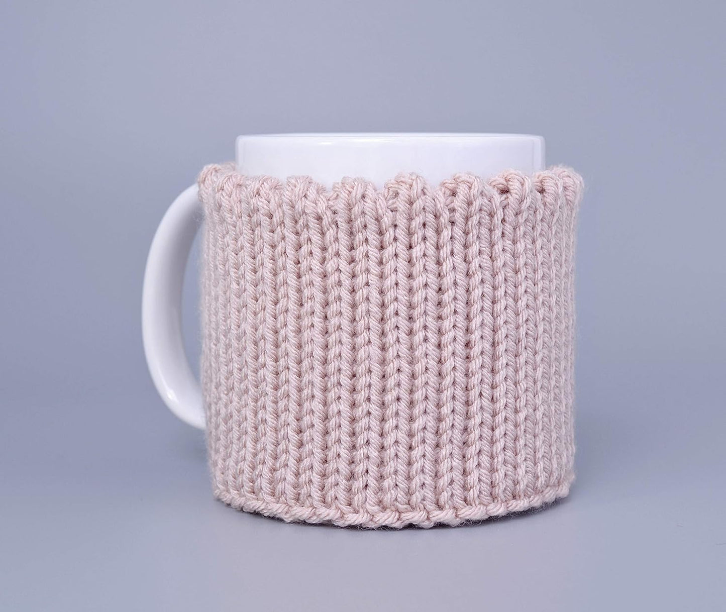 Light pink knitted mug cozy