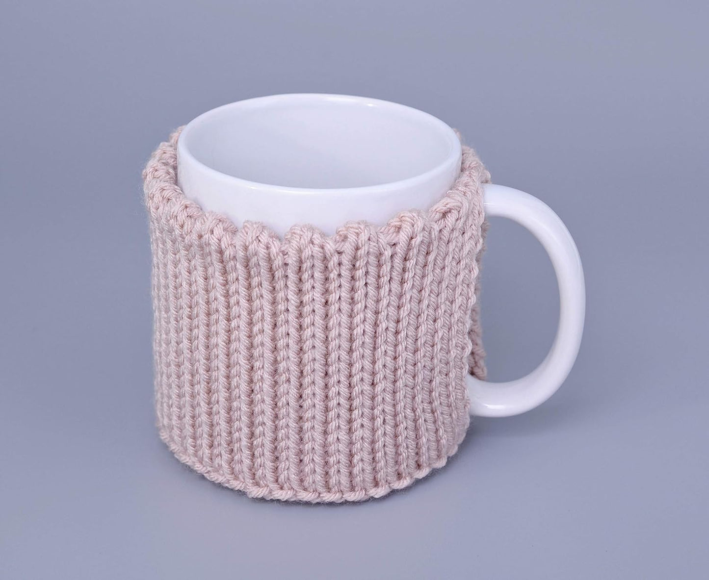 Light pink knitted mug cozy