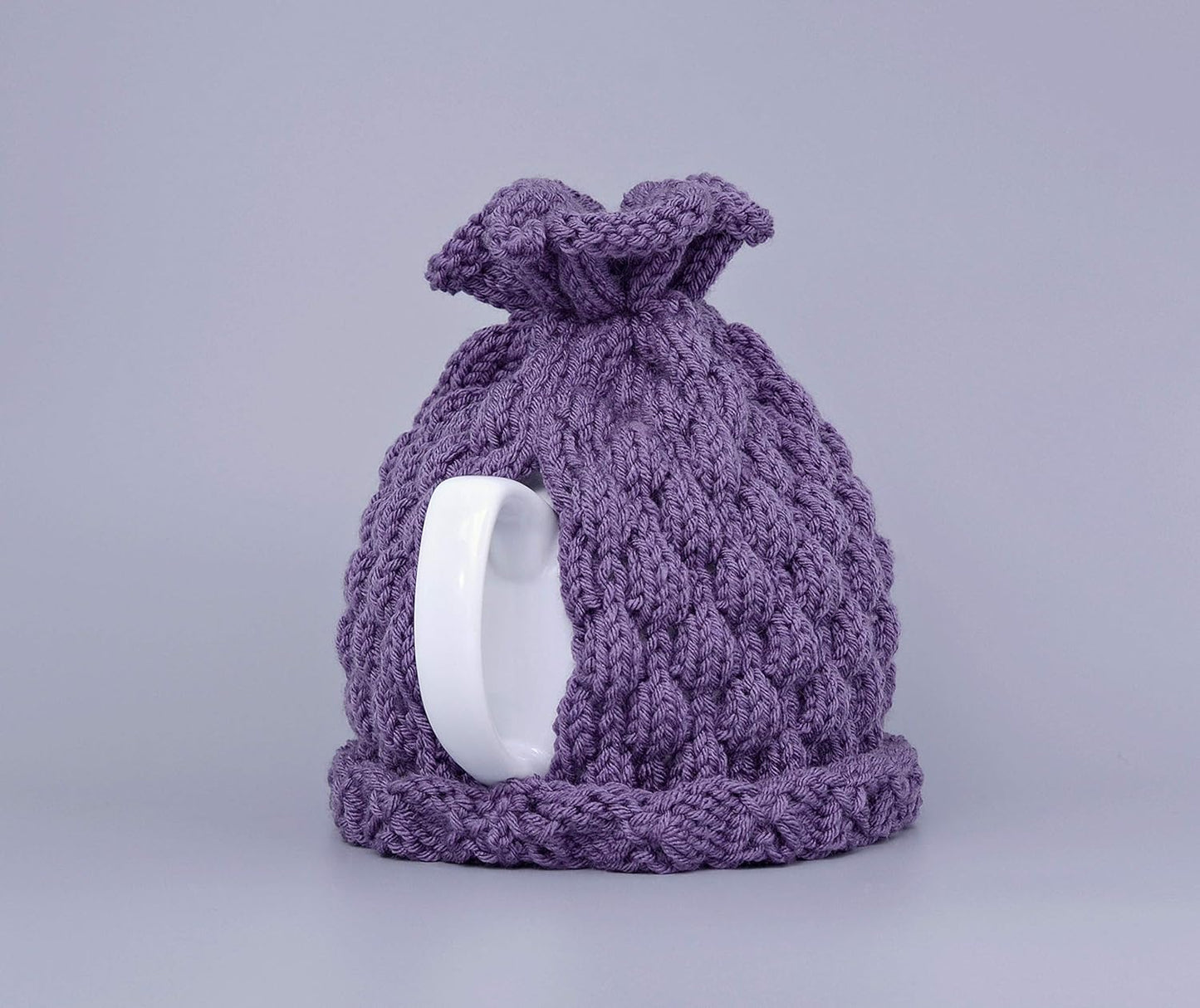 Purple knitted teapot cozy