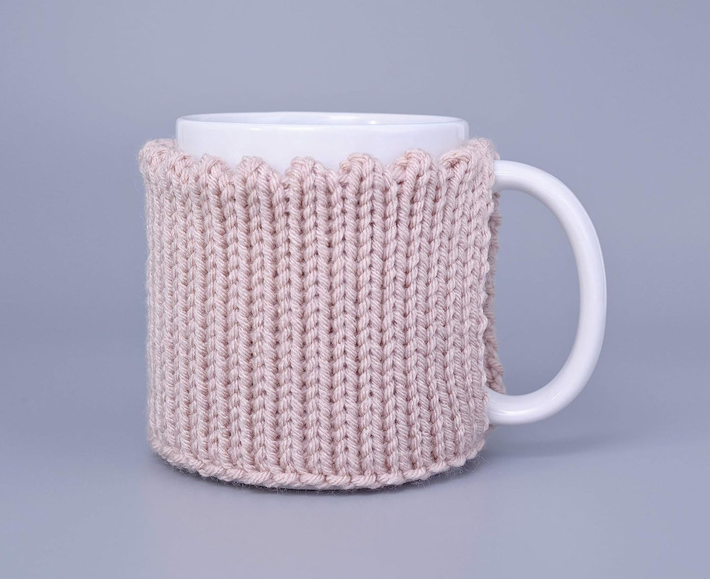 Light pink knitted mug cozy