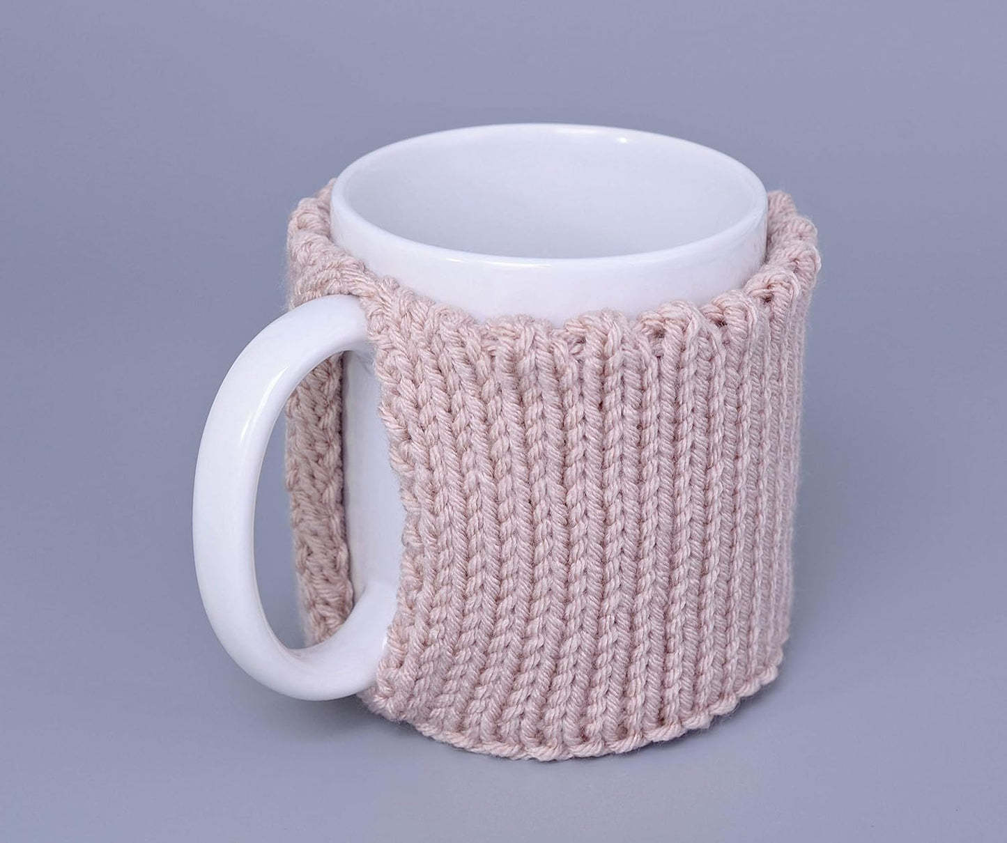 Light pink knitted mug cozy