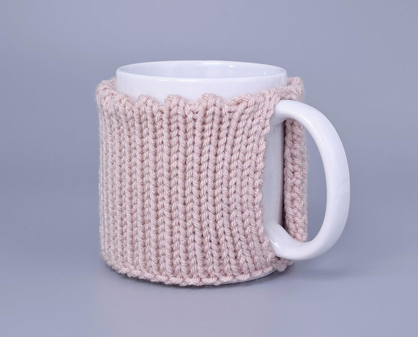 Light pink knitted mug cozy