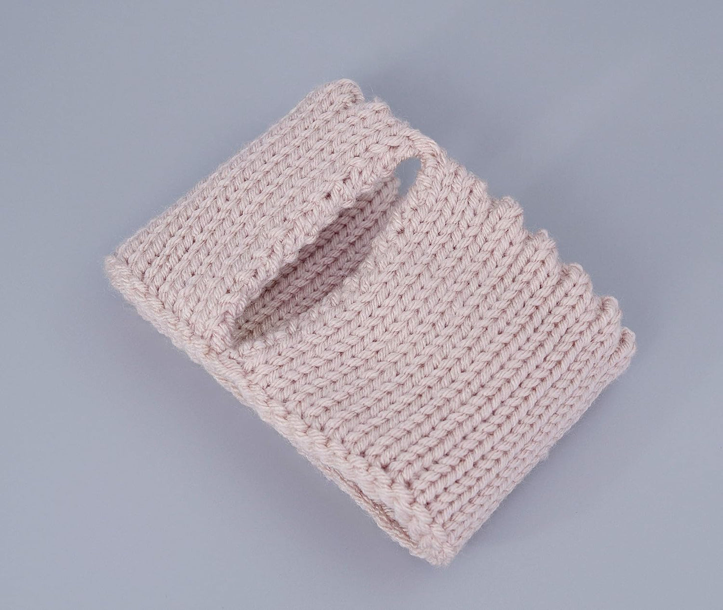 Light pink knitted mug cozy