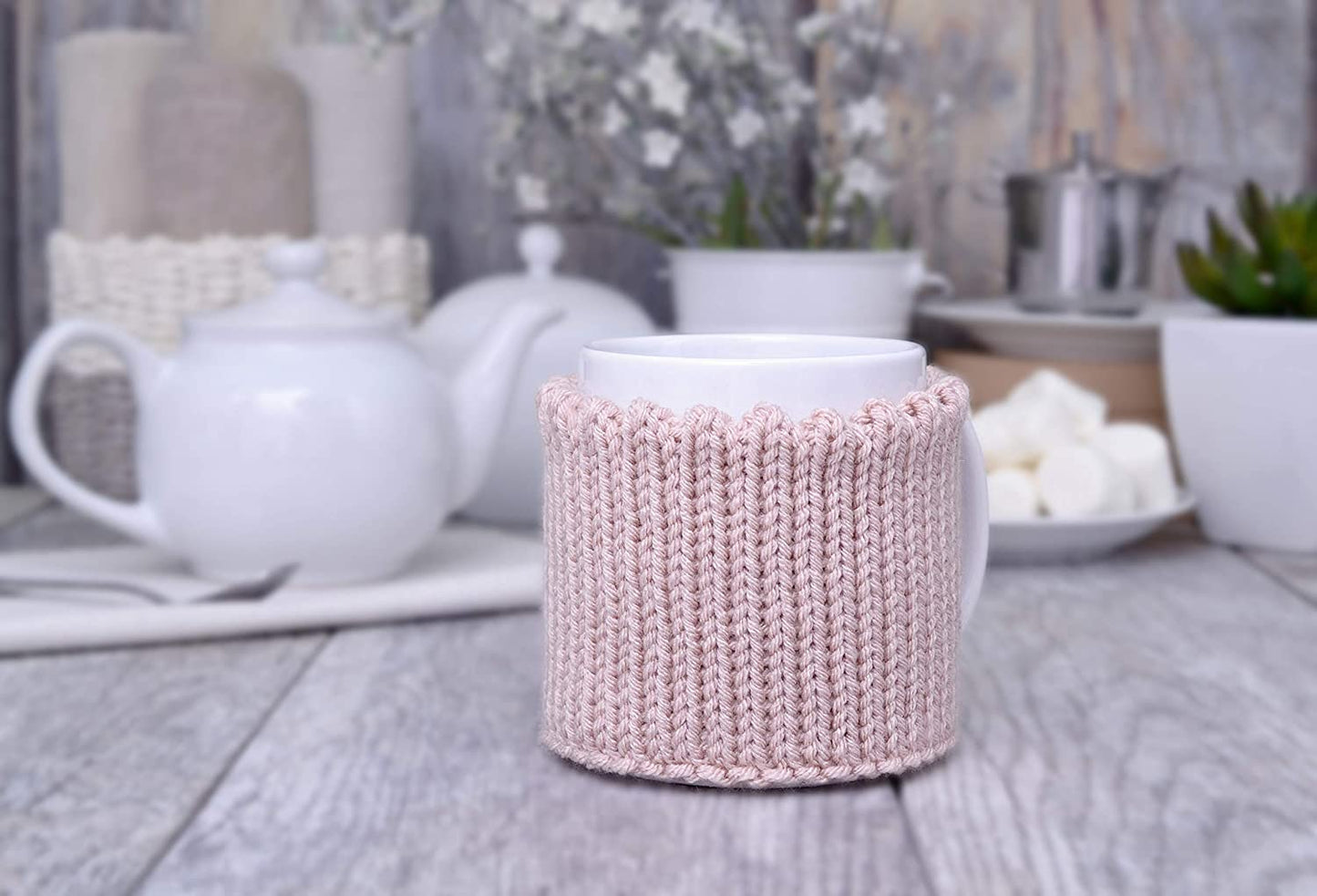 Light pink knitted mug cozy