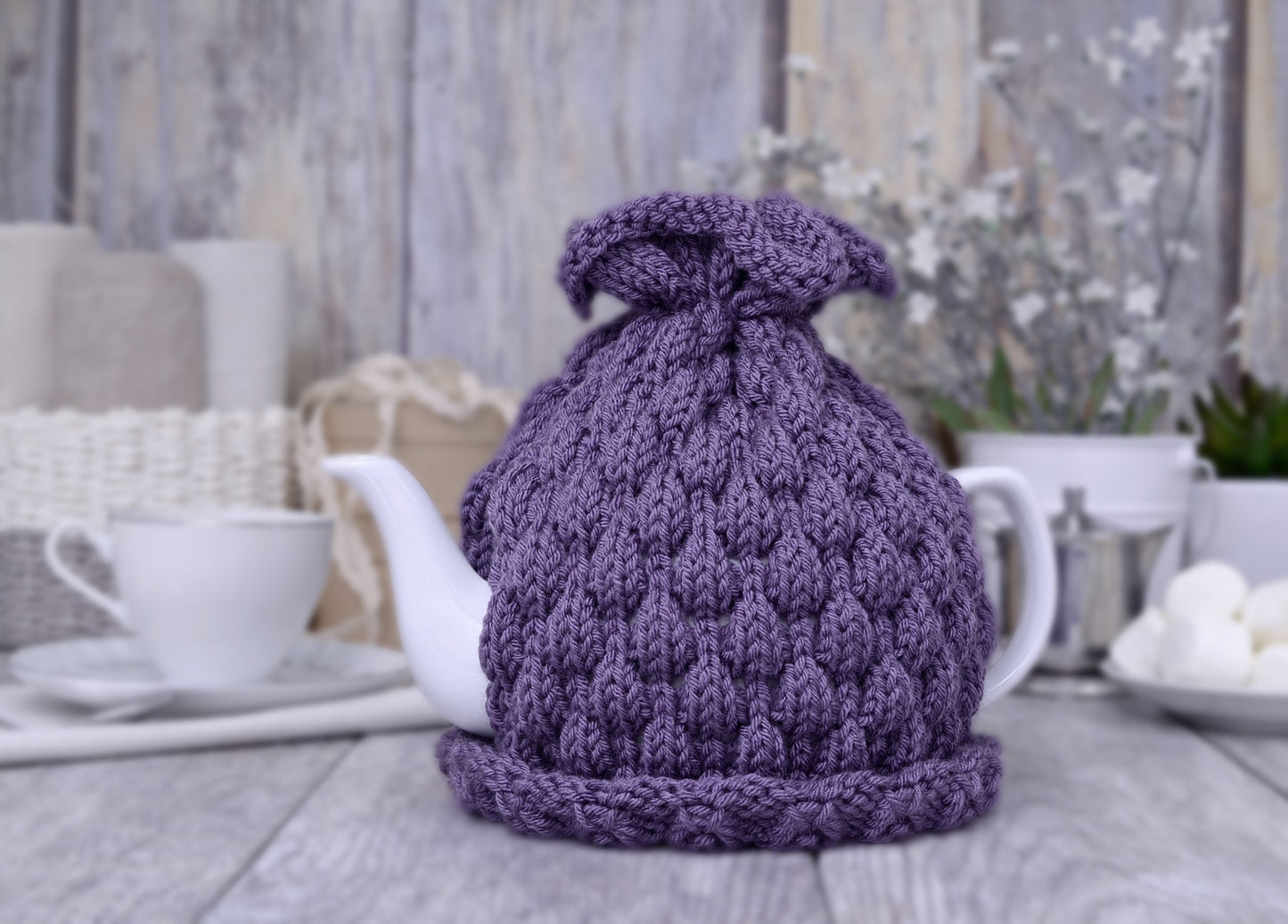 Purple knitted teapot cozy