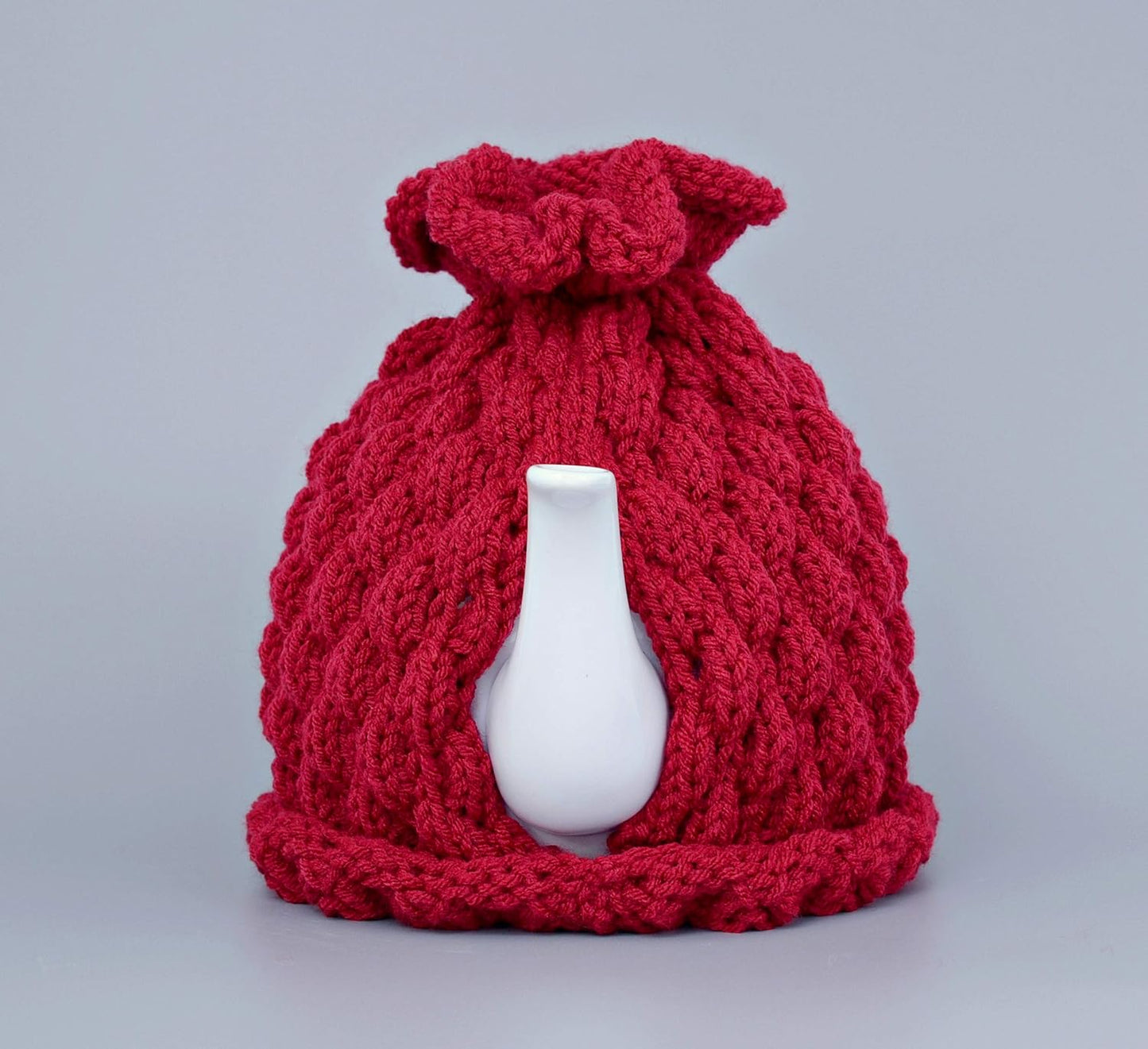 Red knitted teapot cozy