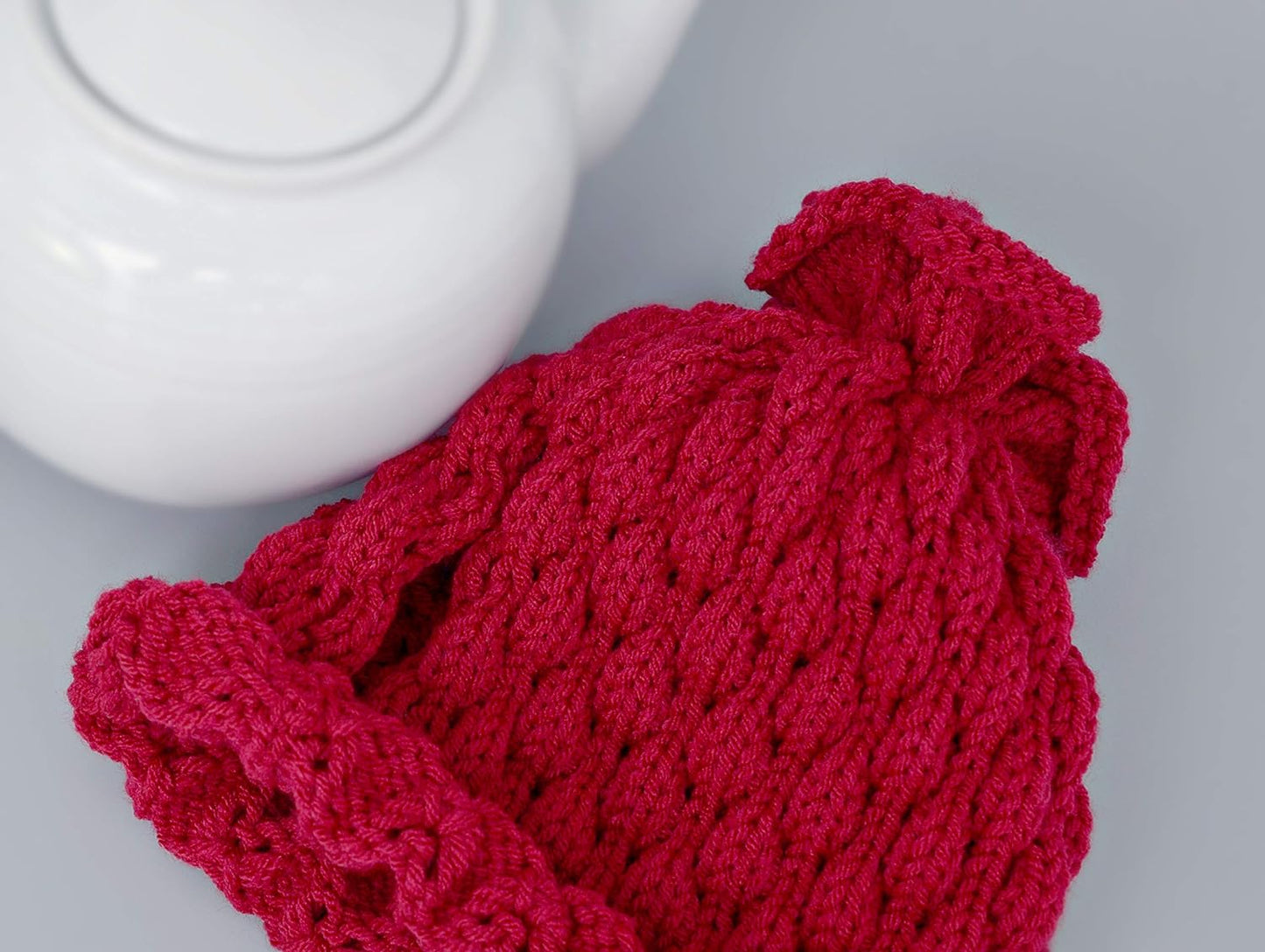 Red knitted teapot cozy