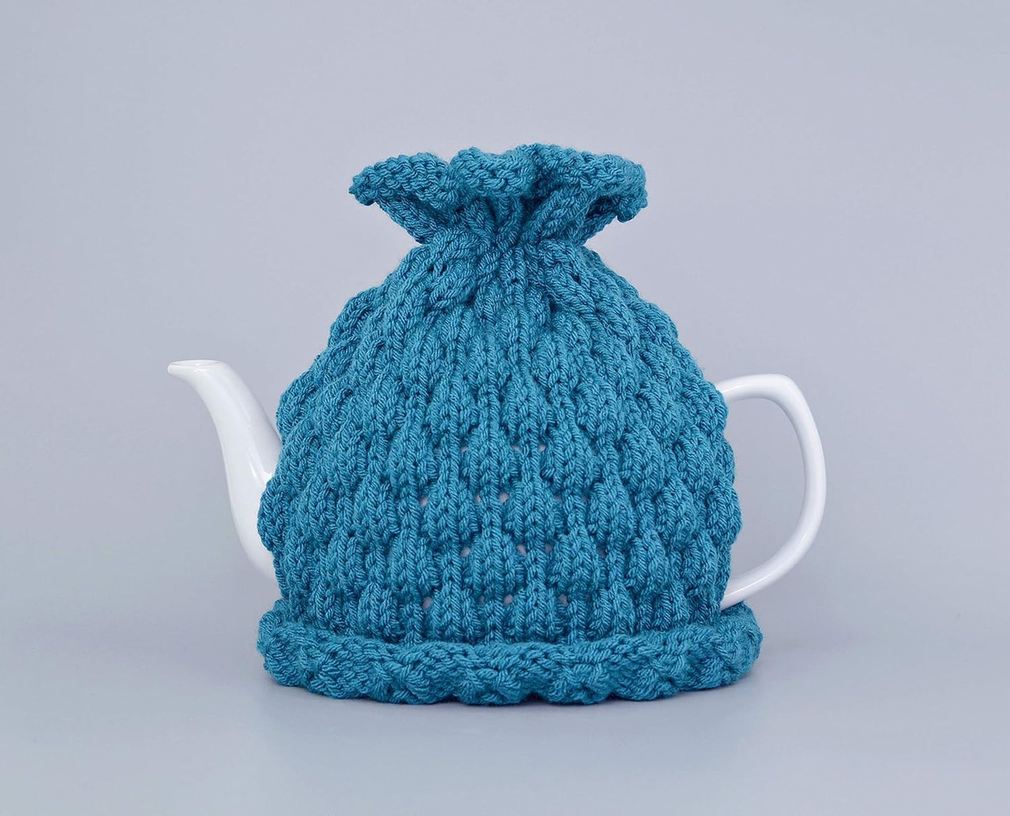 Teal knitted teapot cozy