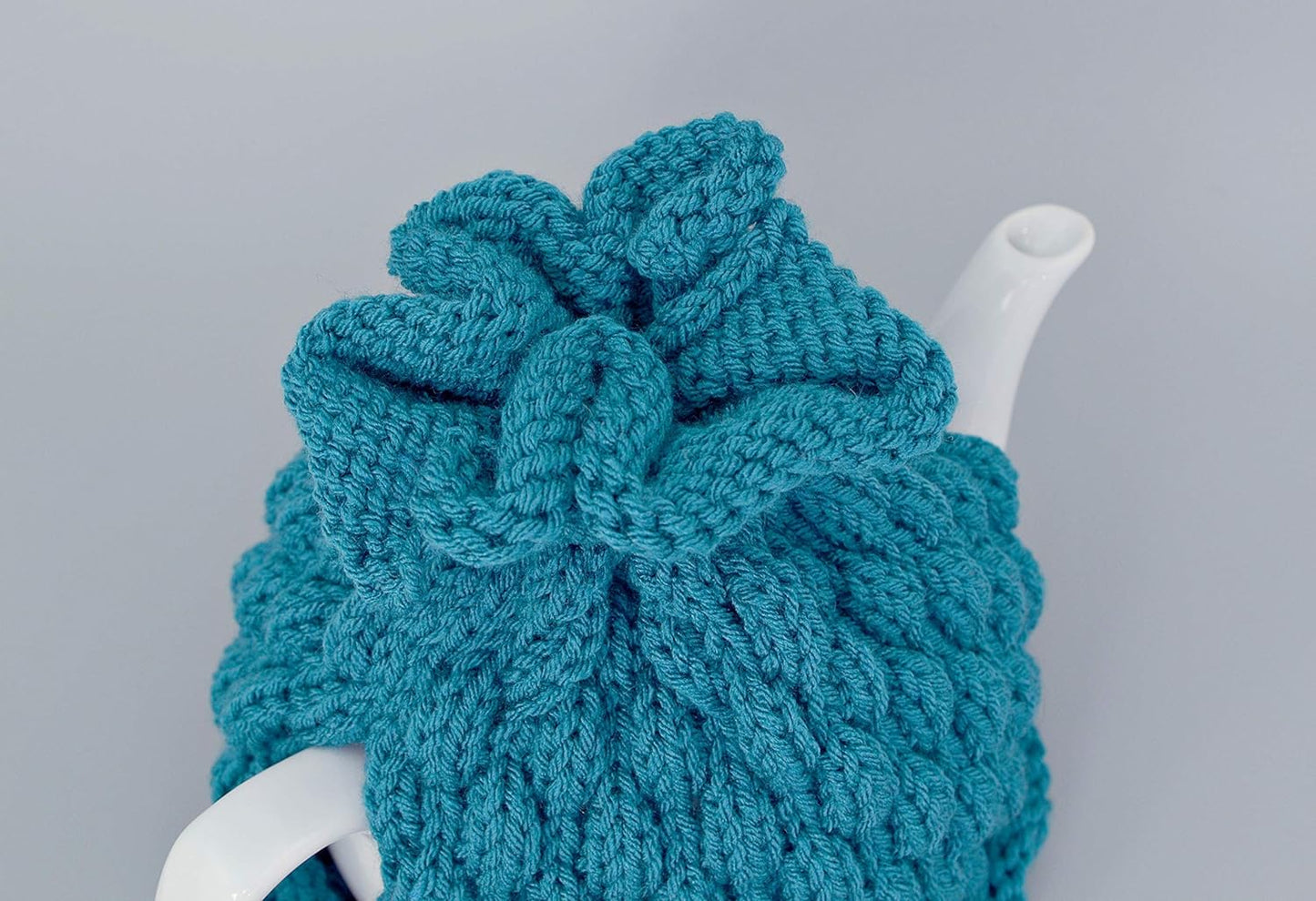 Teal knitted teapot cozy