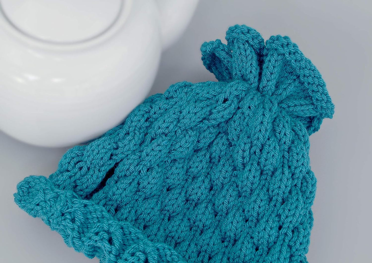 Teal knitted teapot cozy